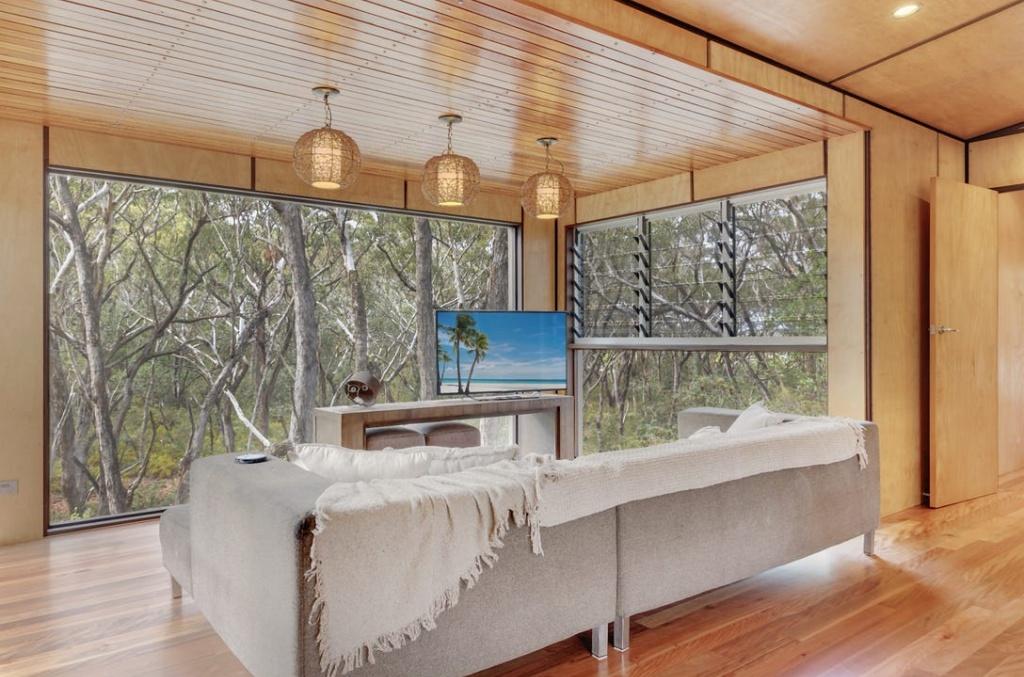 sitting room with smart tv and lounge overlooking forest