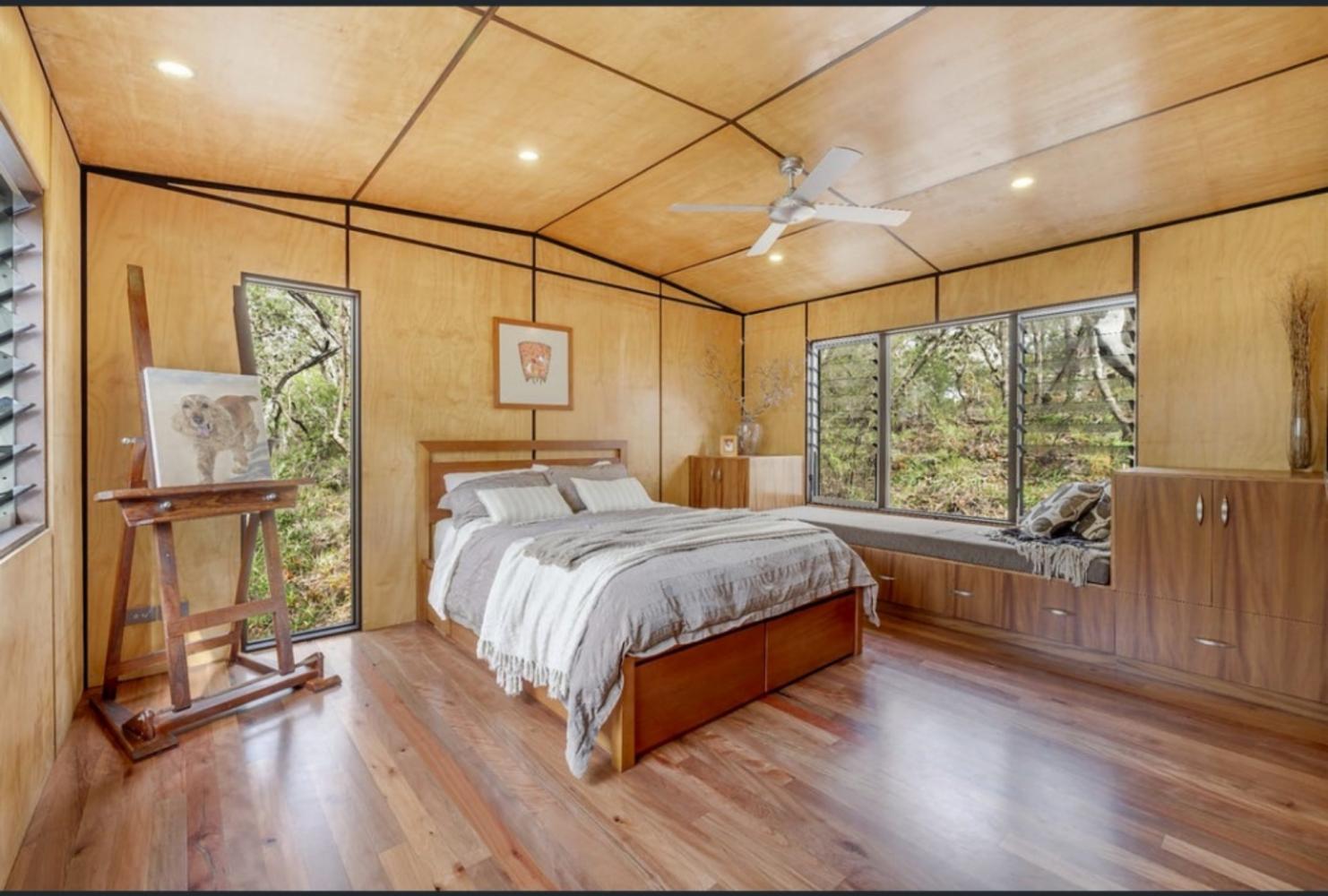 master bedroom with queen bed and ensuite. Views of surrounding forest