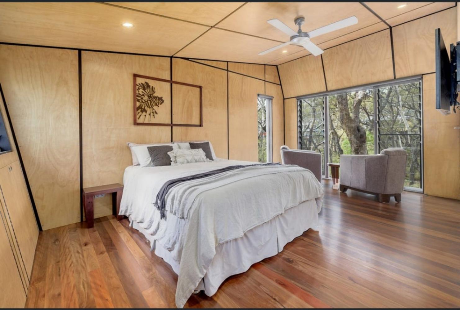 second bedroom with queen bed, ceiling fan, built in robe