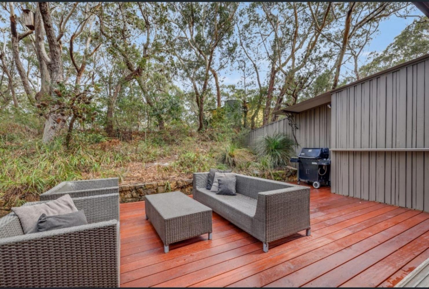 outdoor living area with seating and BBQ for relaxing surrounded by natural forest