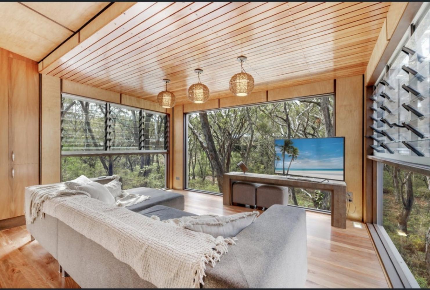 sitting room with smart tv and lounge over looking natural forest