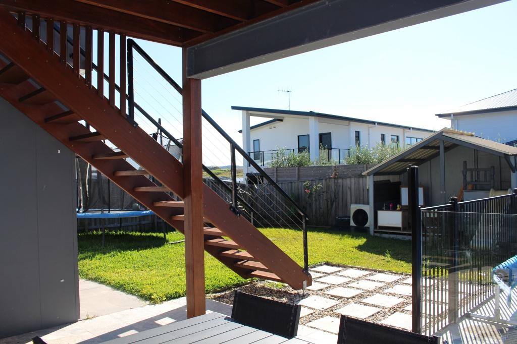 Stairs to the main living and trampoline in backyard at Waterside Escape