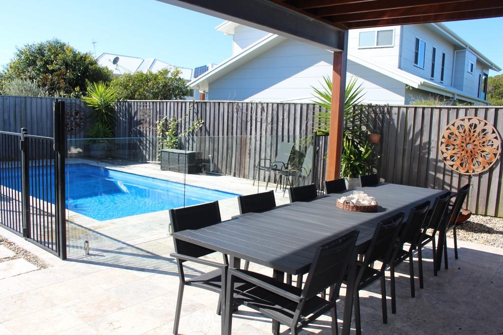 Luxurious heated pool with ten seater outdoor table at Waterside Escape