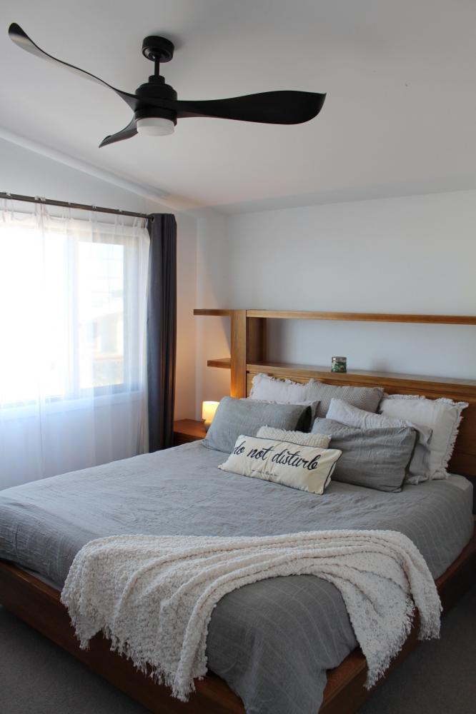 Large master bedroom with ceiling fan and queen bed at Waterside Escape