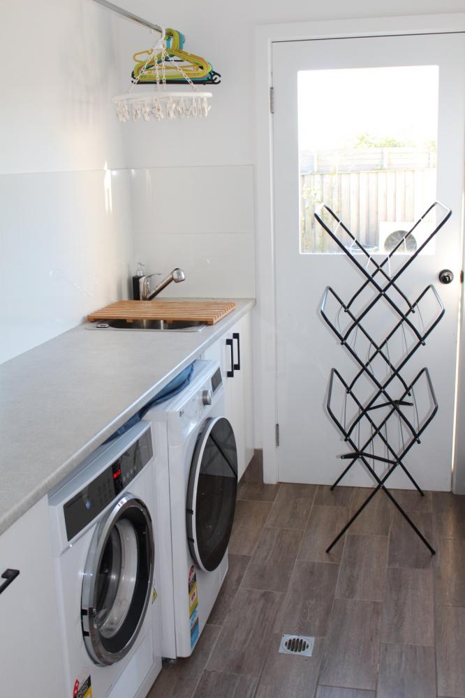 Modern laundry including washer and dryer at Waterside Escape