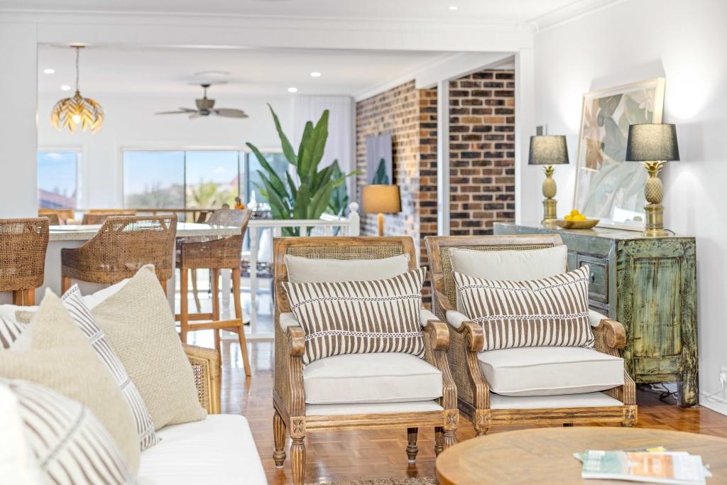 Open planing dining and lounge room with ceiling fan and ducted air conditioning at Beached at Lighthouse Port Macquarie