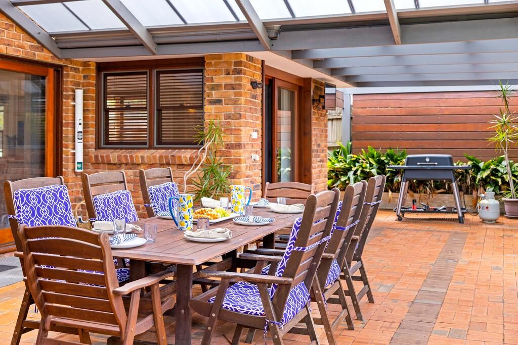 Outdoor dining with BBQ overlooking swimming pool. Illalangi